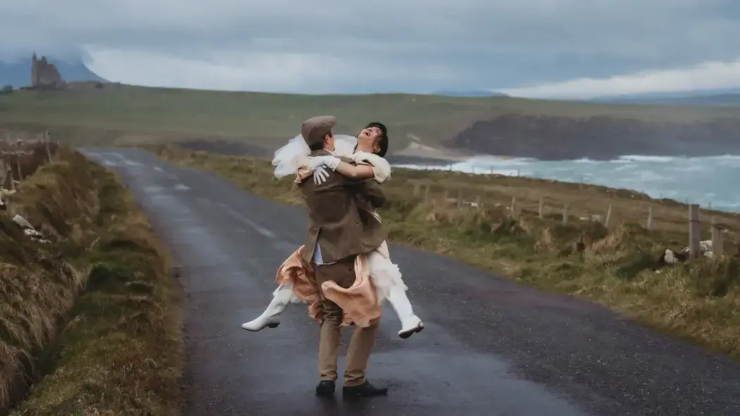 Couple in moody Scotland bride being carried by groom