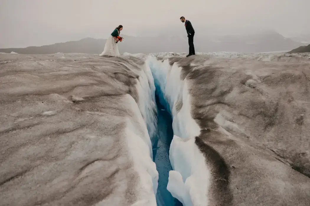 elopement couple overlooking large ice crevasse